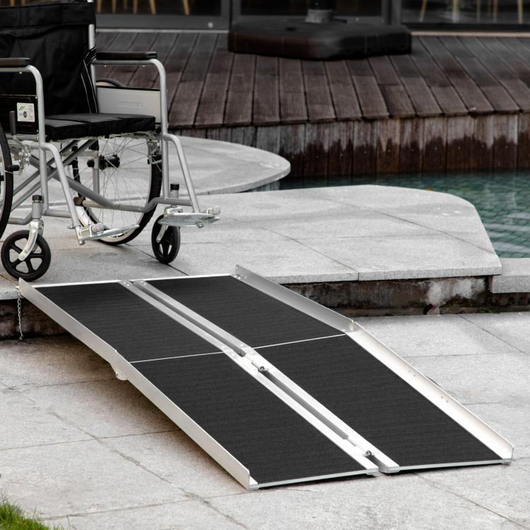 Wheelchair ramp with black grip tread and silver fold-out legs for step access
