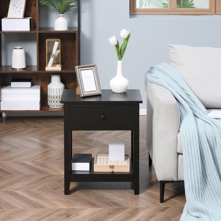 Black end table with drawer and open shelf, vertical panel detailing on sides.