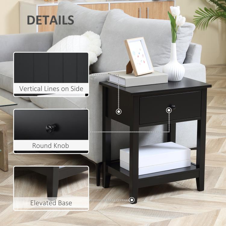 Black side table with round drawer knob, elevated base, and vertical trim details.