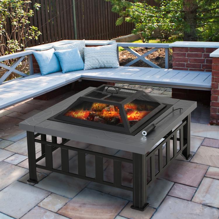 Square steel wood-burning fire pit with mesh spark screen and burning logs