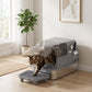 Grey enclosed cat litter box with flip lid, step platform, scoop and deodorizing bags; cat inside.