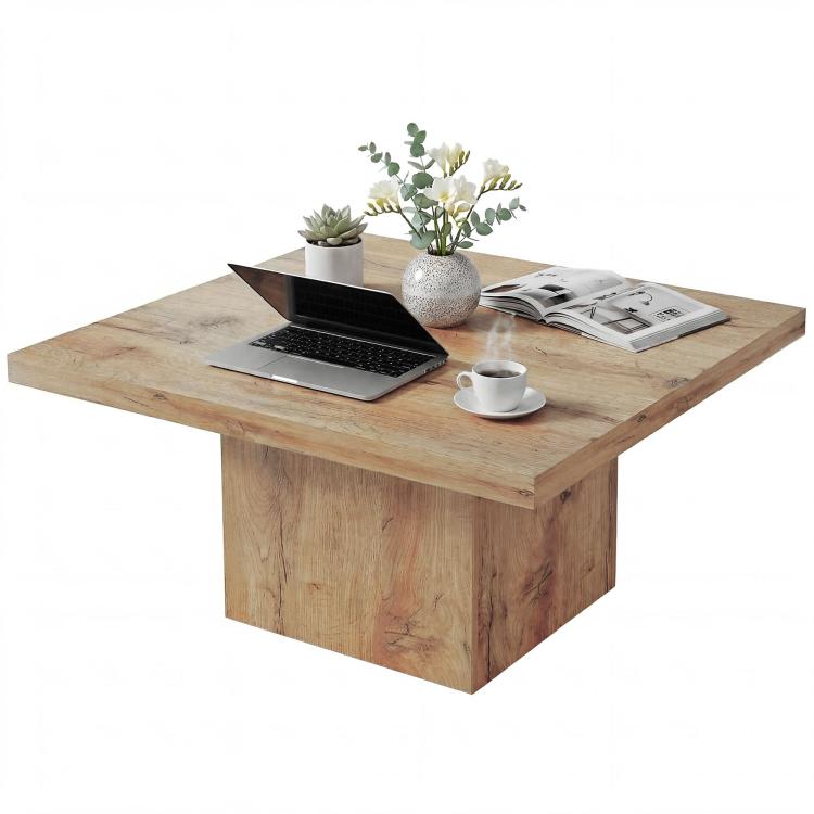 Light brown square coffee table with laptop, cup, and decor on the tabletop