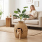 Rattan-style cat litter box enclosure with faux plant top and arched side entrance