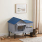 Heated cat house with blue roof, gray sides, elevated base, and front entry
