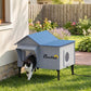 Heated cat house with gray body, blue roof, front door opening, and side oval window