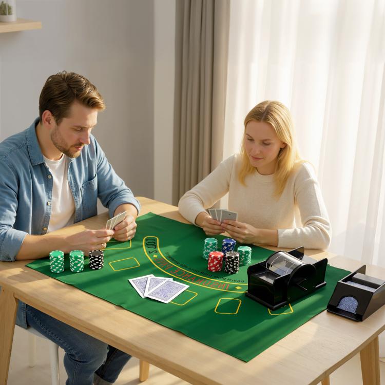 Poker chip set arranged on a green felt table mat with chips and card shuffler