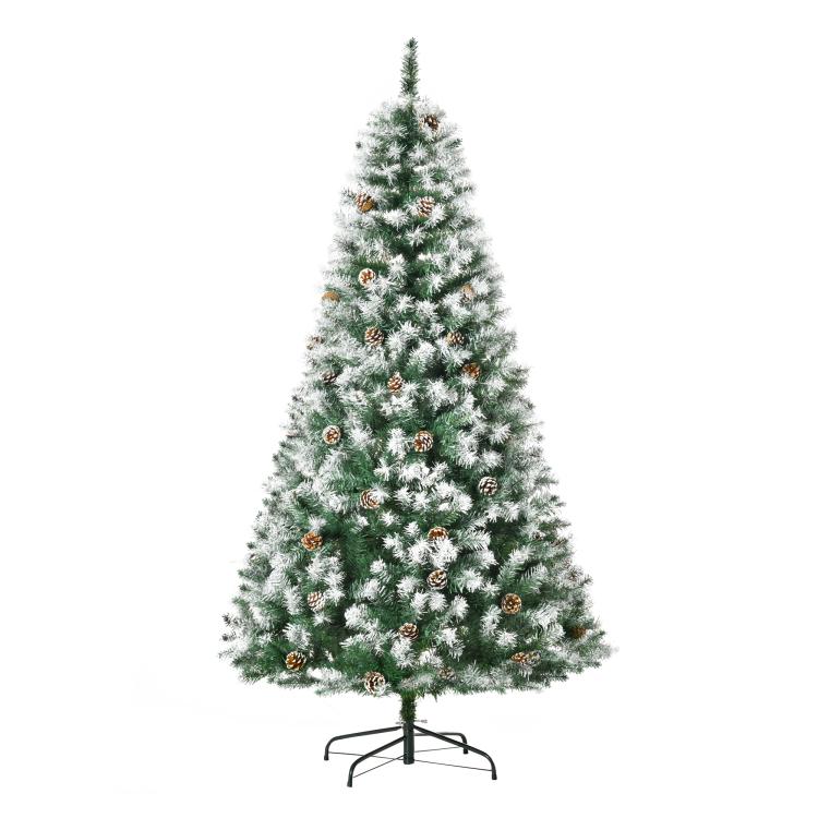Snow-dusted artificial fir Christmas tree with pine cones, side view