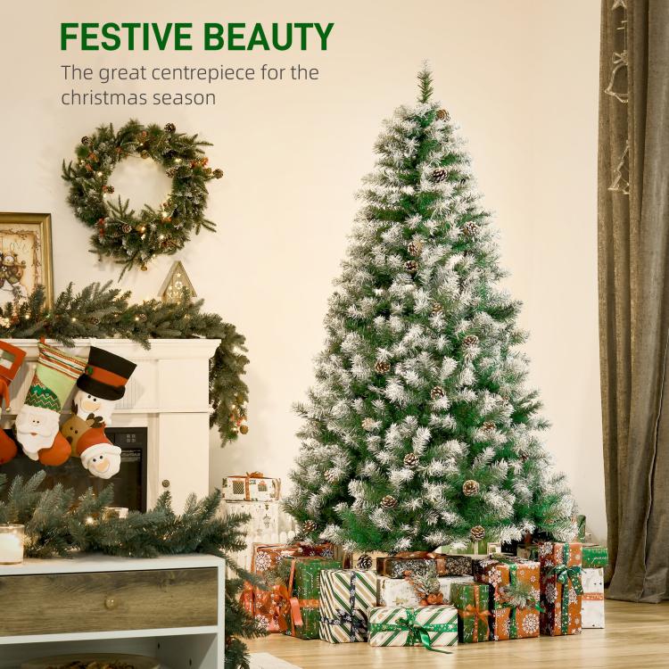 Snow-dusted artificial fir Christmas tree with pine cones and full layered branches
