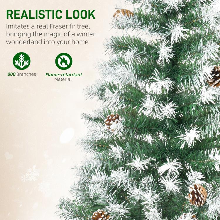 Frosted artificial fir branch tips with snow-dusted needles and pine cone