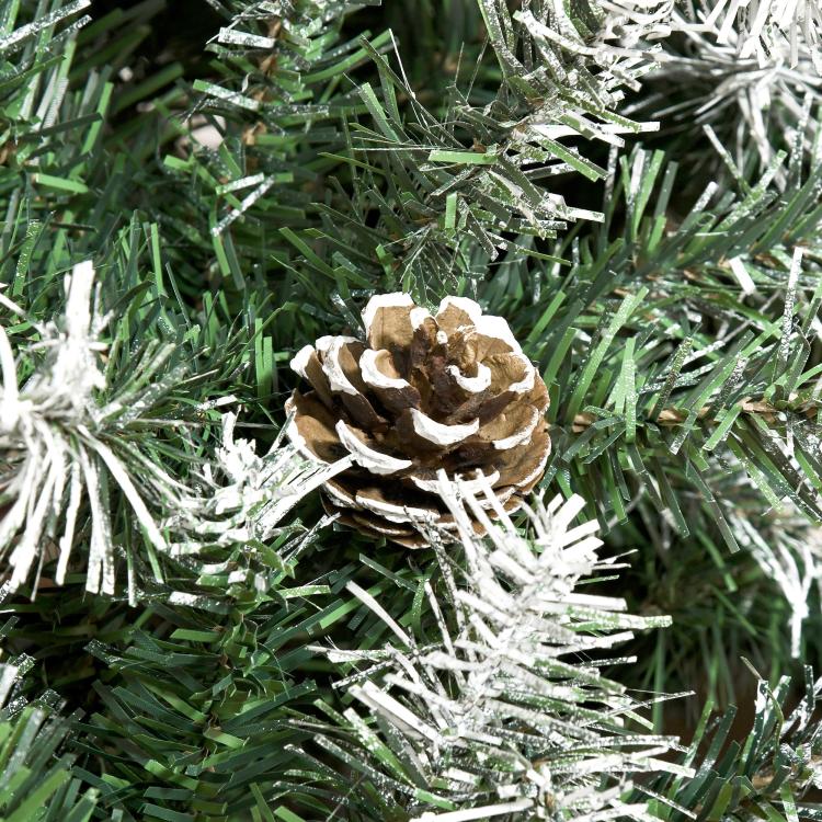 Close-up of a pine cone on snow-dusted artificial fir needles