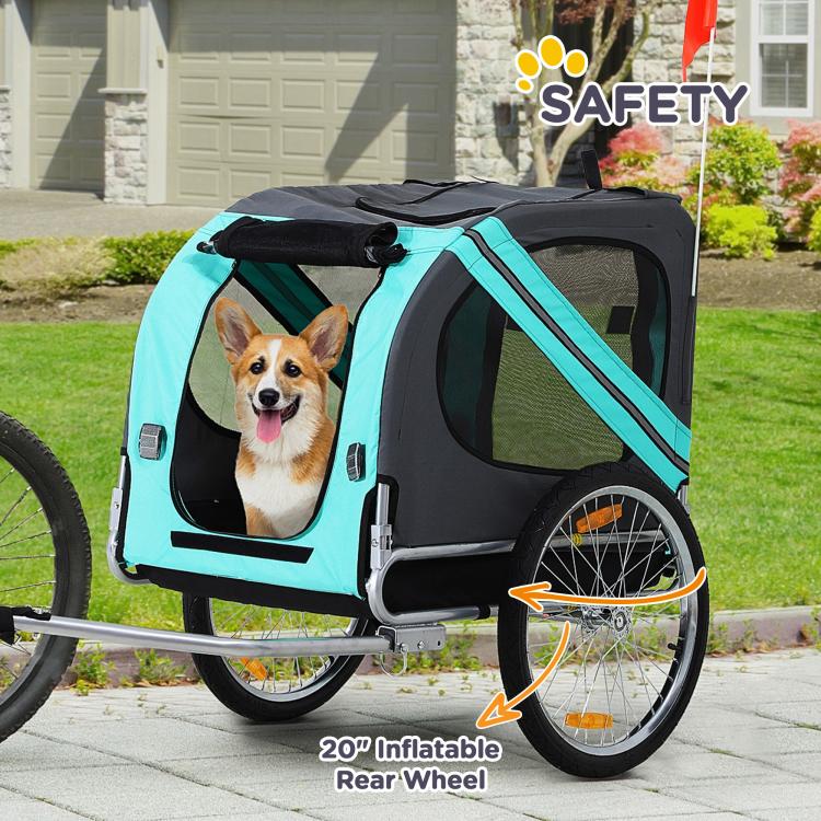 Green dog bike trailer with mesh sides, inflatable rear wheel, and safety flag