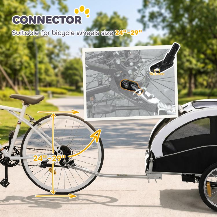 White pet bike trailer with connector hitch attached near bicycle front wheel