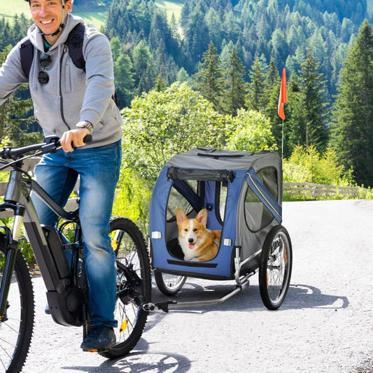 Blue and grey pet bike trailer with mesh sides, front door, and small dog inside