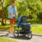 3-wheel pet stroller rolling outdoors, teal canopy over dark mesh sides and front viewing window