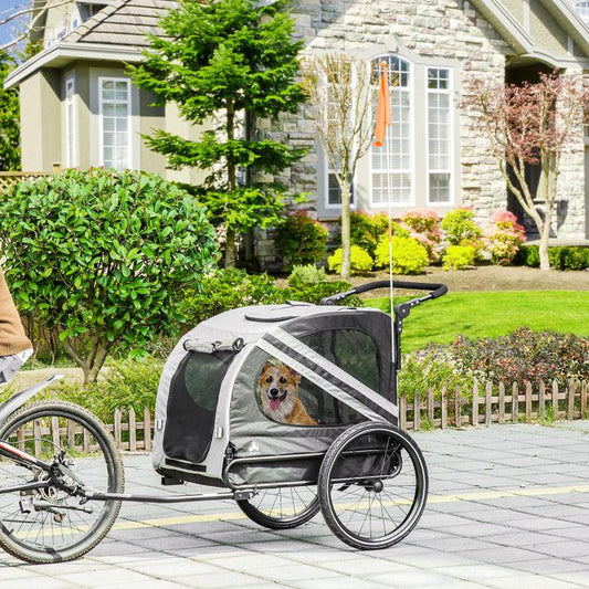 Gray pet bike trailer with front glass-style window, mesh sides, and dual rear wheels