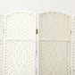 White folding divider screen hinge and woven panel seam, close-up
