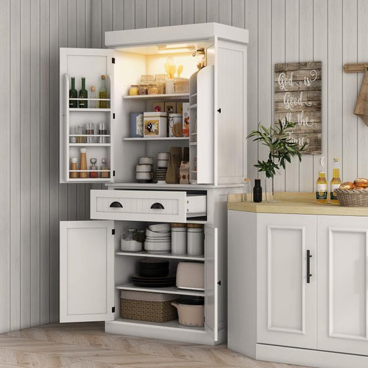 White kitchen pantry cabinet with open doors, interior shelves, and center drawer