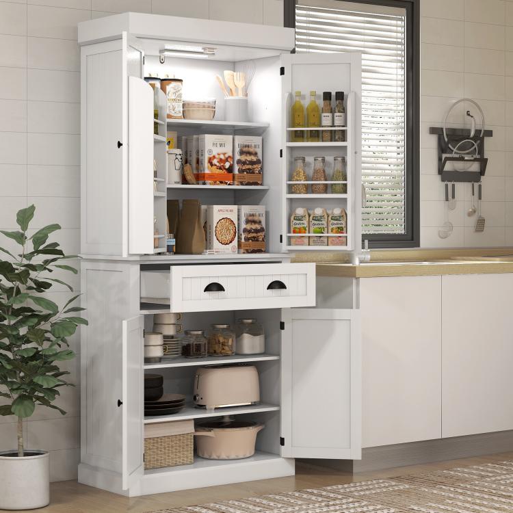 White kitchen pantry cabinet with open doors and drawer, showing organized interior shelves