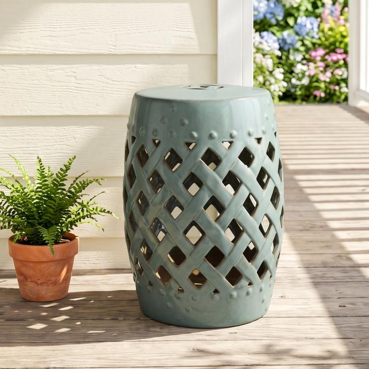Ceramic garden stool with glazed teal top and diamond lattice cutout body