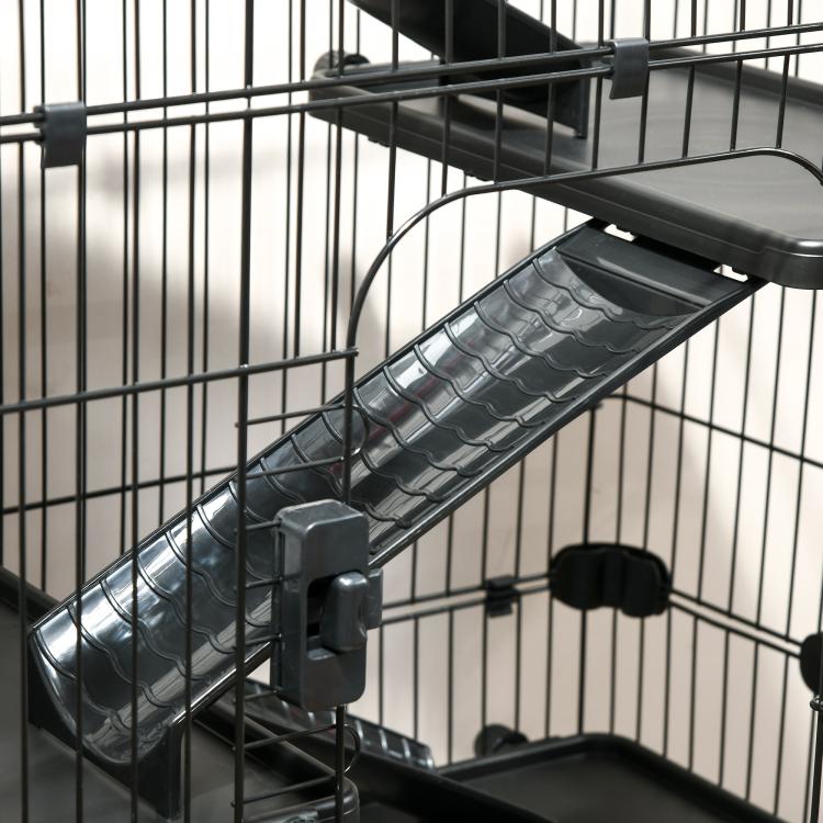 Close-up of black wire cage ramp with textured step surface and side barrier