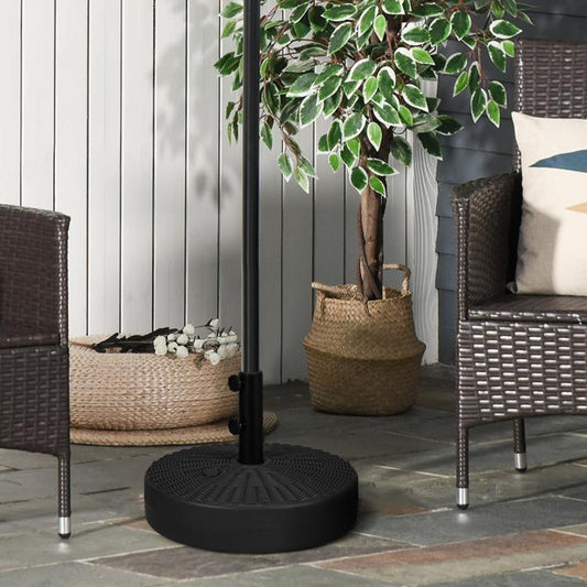Black umbrella base with vertical pole sleeve and two side knobs, standing outdoors