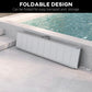 Foldable aluminum wheelchair ramp laid flat with textured silver tread and securing strap
