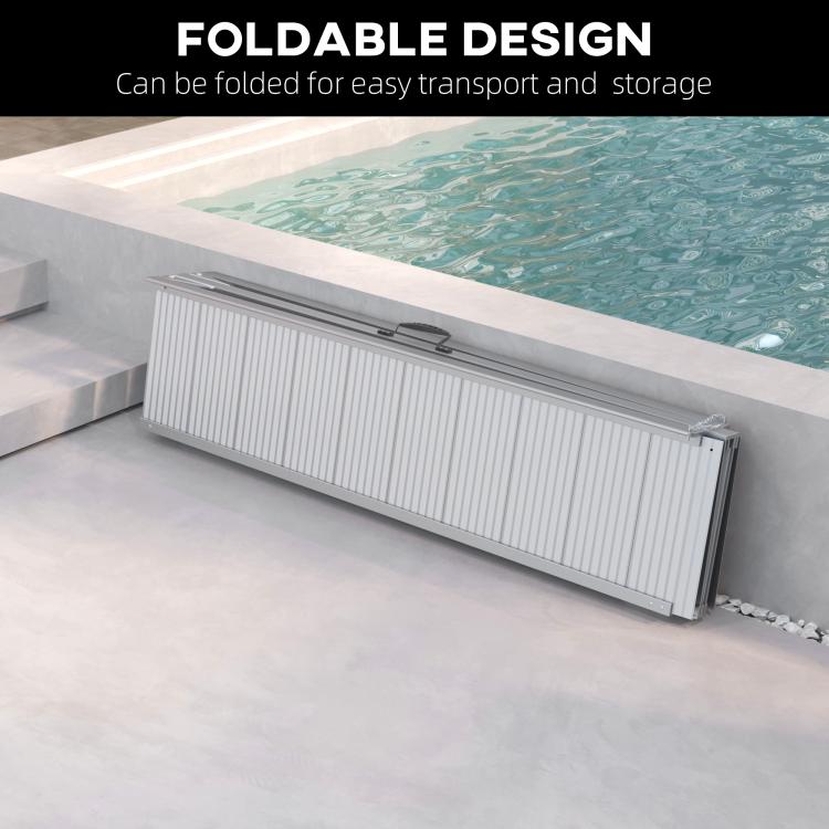 Foldable aluminum wheelchair ramp laid flat with textured silver tread and securing strap