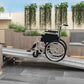 Aluminum wheelchair ramp with textured silver traction, wheelchair positioned for entry access