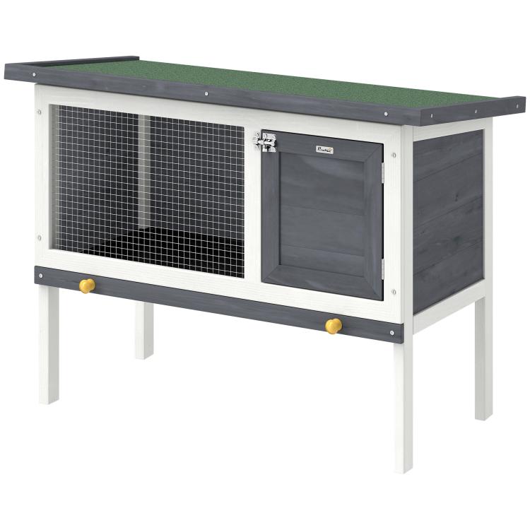 Outdoor elevated rabbit hutch with wire mesh front and large dark door, raised legs