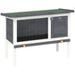 Outdoor wooden rabbit hutch with wire mesh front, dark door, elevated legs
