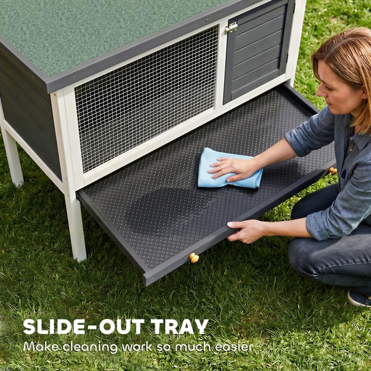 Outdoor elevated rabbit hutch with slide-out bottom tray under the mesh enclosure
