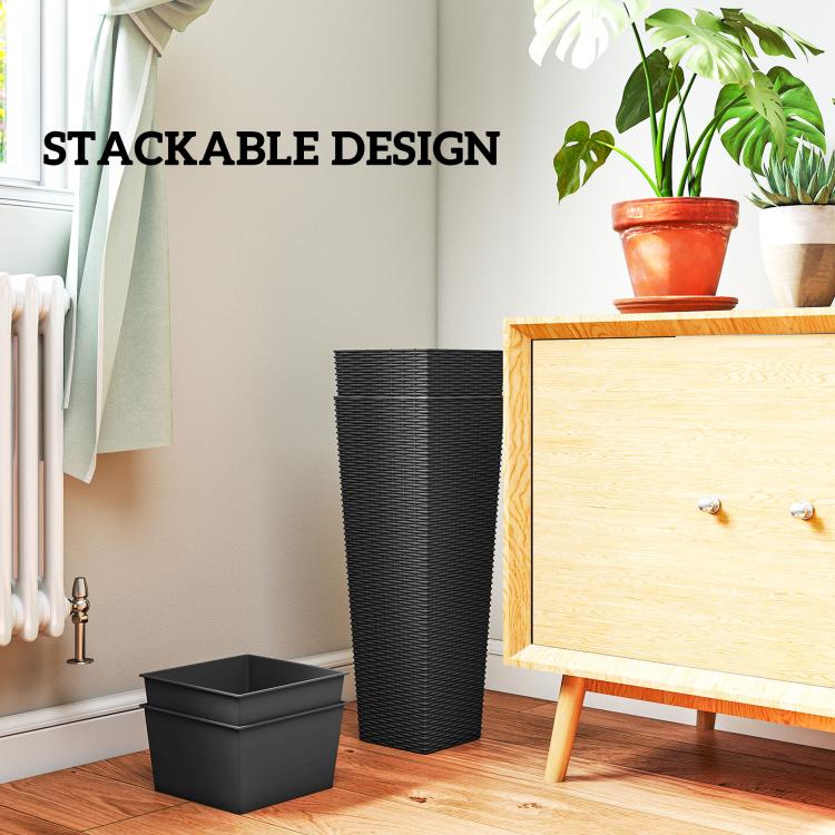 Black tall woven planter with stackable base tray beside potted plants indoors