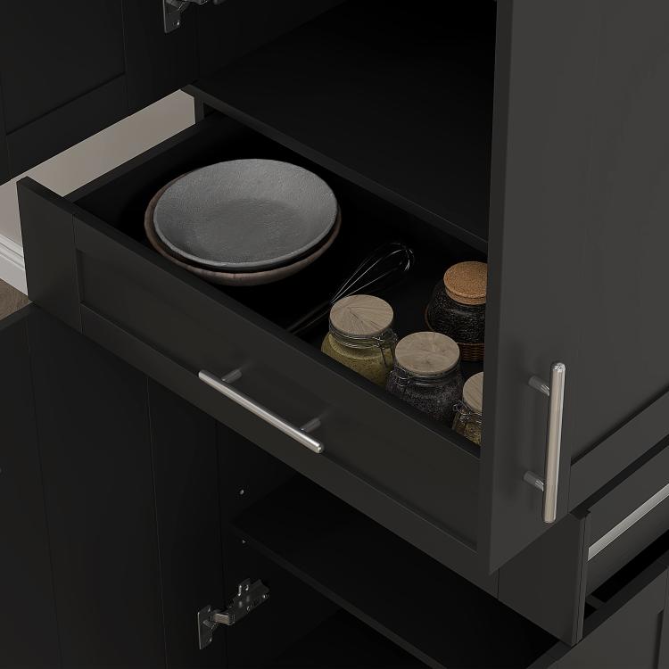 Black drawer pulled open showing plates and small storage items on interior surface