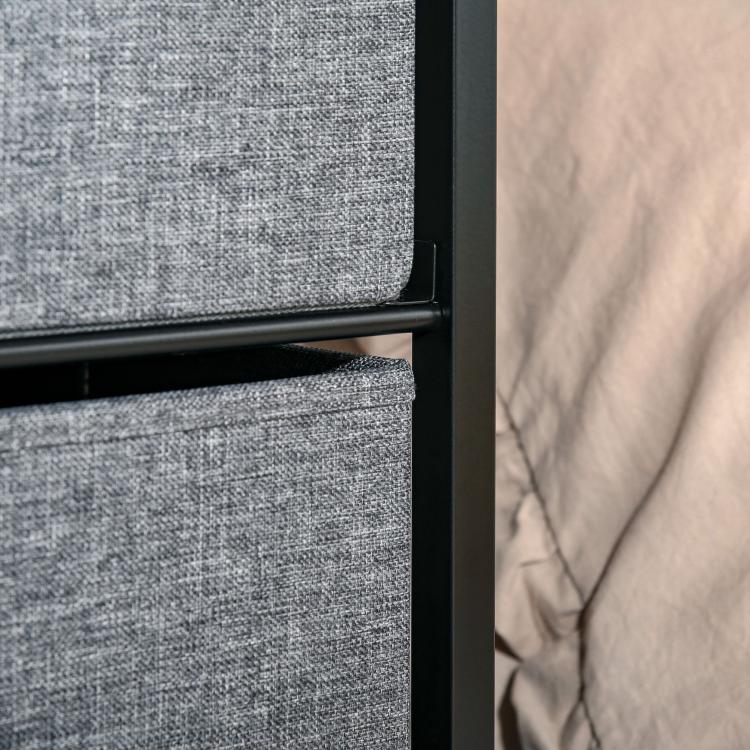 Gray fabric drawer front with black steel frame edge on a drawer chest dresser