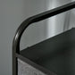 Black curved metal handle and dark tabletop edge on gray drawer chest