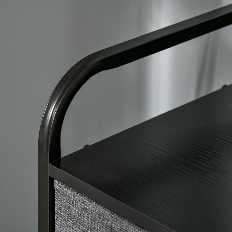 Black curved metal handle and dark tabletop edge on gray drawer chest