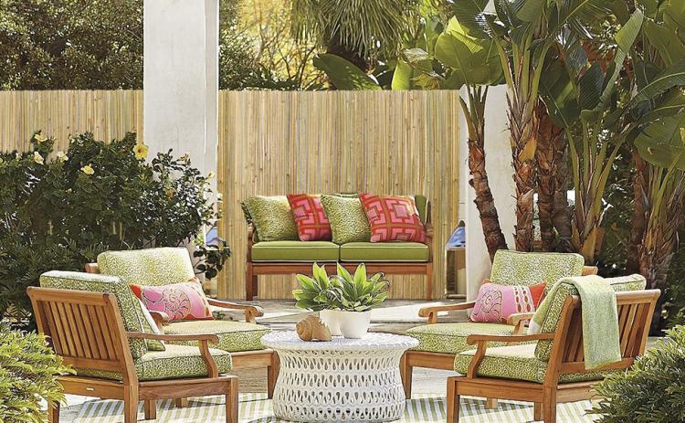 Natural bamboo privacy fence panels along an outdoor patio with plants