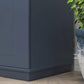 Freestanding navy pantry cabinet side view with base and tall cabinet panel