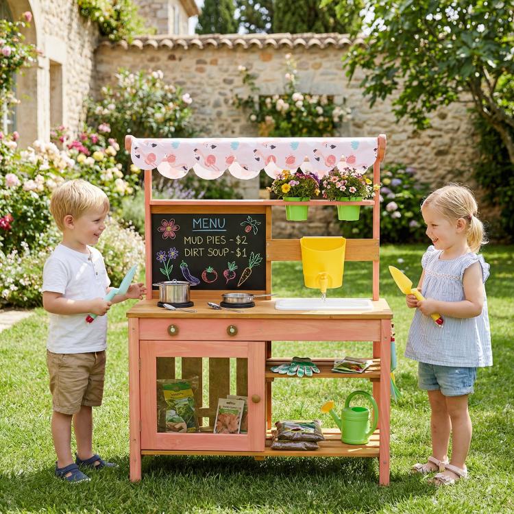 Outdoor kids mud kitchen with canopy, chalkboard menu, planter boxes and yellow sink