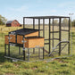 Large outdoor chicken coop with wooden nesting boxes, wire mesh run, and black roof