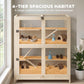 Wooden 4-tier small animal habitat with mesh panels, ramps, and blue water bottle