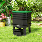 Dark green worm composter bin with open drawer under stacked trays in outdoor garden