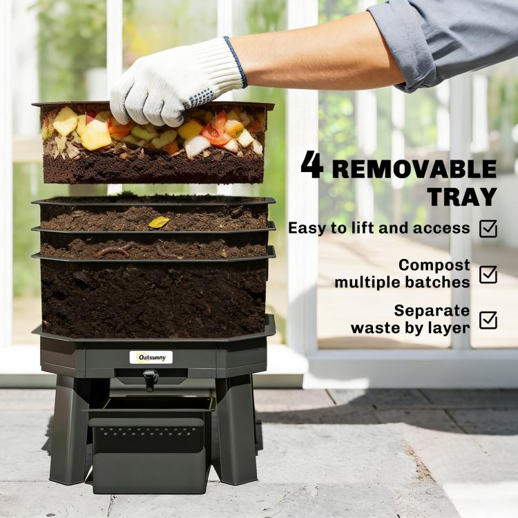 Worm composter with open trays of food waste and gloved hand lifting the green lid