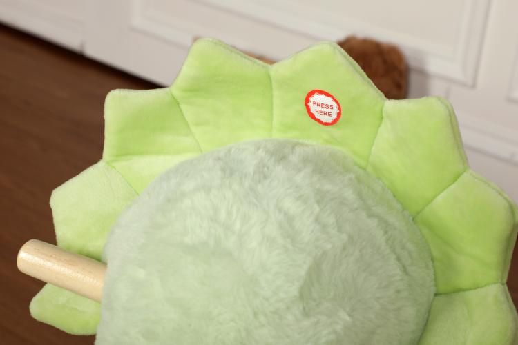 Green plush dinosaur rocking horse head and spiky back detail