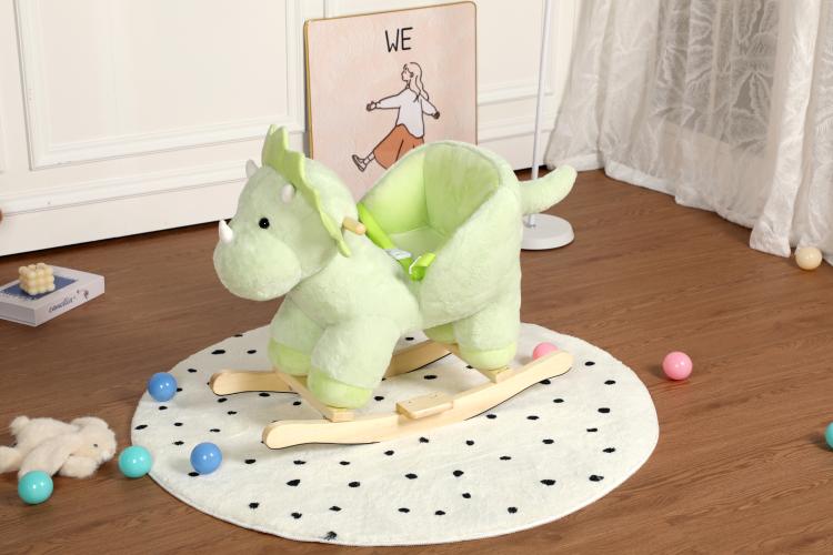 Green plush dinosaur rocking horse side view with wooden rocker and dotted mat