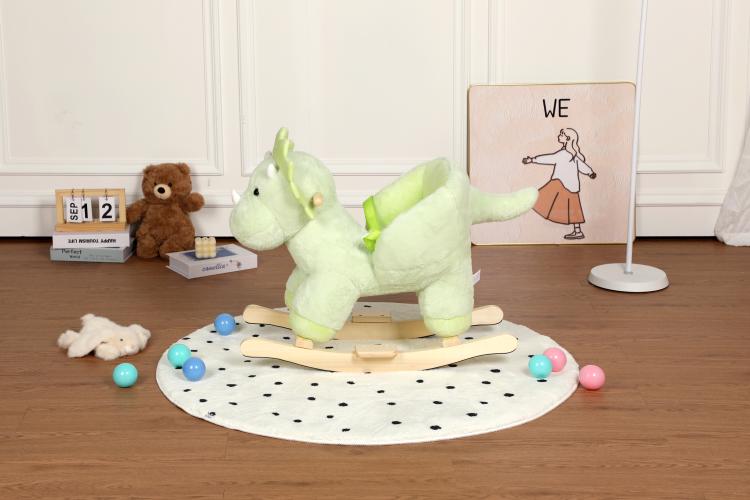 Green plush dinosaur rocking horse full view on a round dotted mat