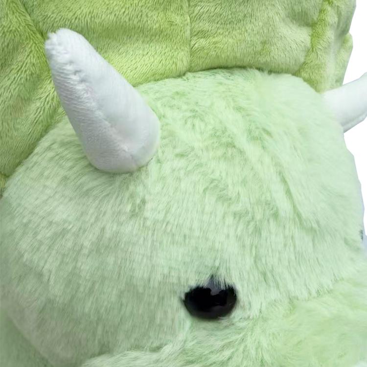 Green plush dinosaur face with white belly and stitched snout detail