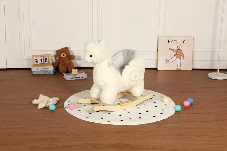 White plush alpaca rocking toy on circular mat with wooden rocker base