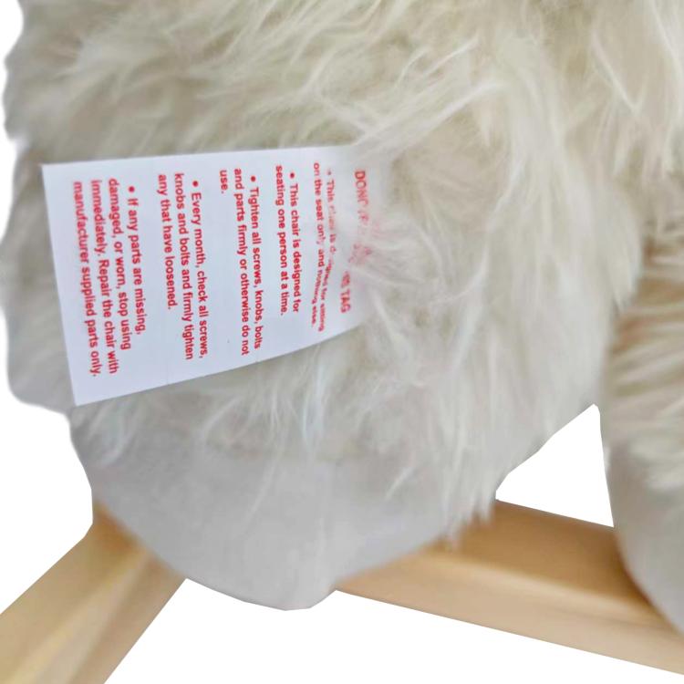 White plush rocking horse with instruction label on back