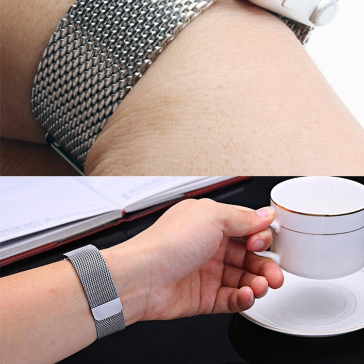 Stainless steel Milanese loop watch strap on wrist with clasp visible, silver tone